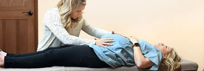 Chiropractor Holmen WI Kaitlyn Canar Adjusting Pregnant Woman
