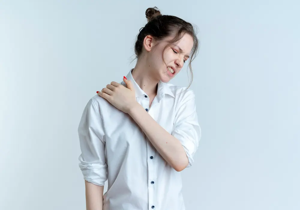 Person holding shoulder due to chronic pain and discomfort