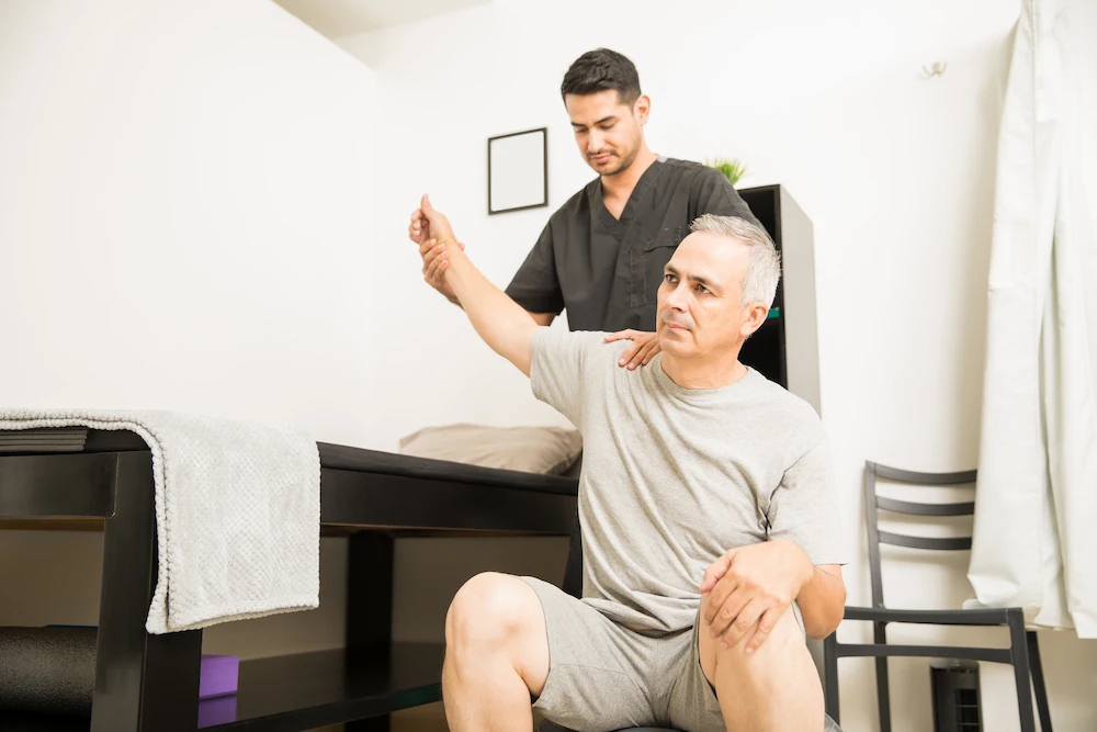 Older adult receiving chiropractic adjustment to improve mobility and reduce joint stiffness