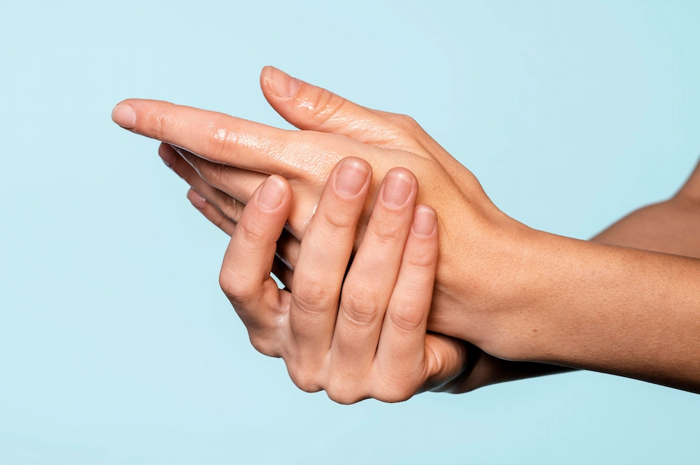 Person rubbing hands due to numbness and tingling sensations